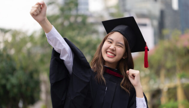 Successful graduation from university. Smiling beautiful Asian g